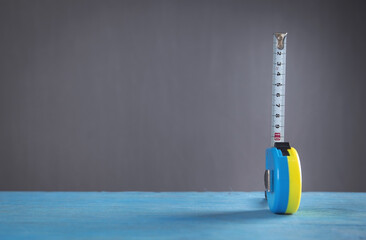 Measuring tape on the blue table.