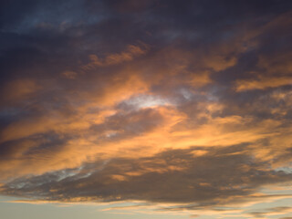 Naklejka na ściany i meble Clouds in the sunset sky.
