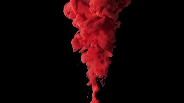 Crimson red color cloud dispersing in water. Captured in 4k resolution in slow motion against a black background. Halloween, Horror Concept.  