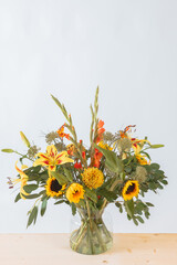 Autumn bouquet with sunflowers, gladioli, chrysanthemum, gladiolus, lily, montbretia, eucalyptus branches. Magnificent flower arrangement with an autumn mood. white background