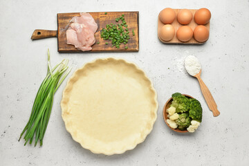 Raw dough with ingredients for preparing pot pie on light background