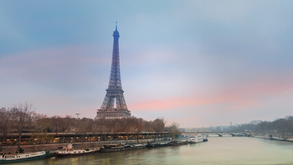 The Eiffel Tower, iconic Paris landmark across the River Seine with  the tourist boat  in  sunset sky scene at Paris ,France  background