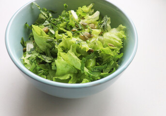 fresh salad leaves with pumpkin seeds in a plate, close-up. Comfortable digestion, proper nutrition, weight loss. The texture of vegetables, salad. Seasonal vitamins, fiber