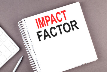 IMPACT FACTOR text on notebook with calculator and pen,business concept