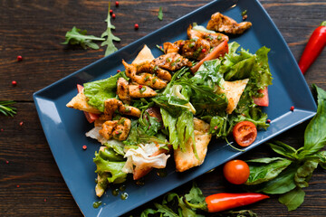 Health food for fitness with chicken, vegetables, herbs, spices and olive oil. High in antioxidants, minerals and vitamins. Healthy homemade chicken salad, diet food, vitamin snack.