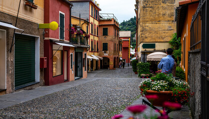 Narrow cozy street in Portofino Italian fishing village with colorful facades and luxury shops.Genoa province, Italy. A vacation resort with a picturesque harbour.