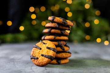 orange cookies with black stripes and fir tree branches. Christmas holiday sweet dessert. Concept...