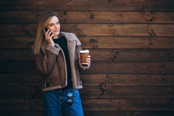 Woman outside on the wooden background