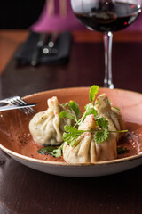 Traditional Georgian Khinkali dumplings chinkali and glass of red wine on the table
