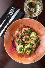 Homemade meat dumplings with spinach on top russian pelmeni on the table