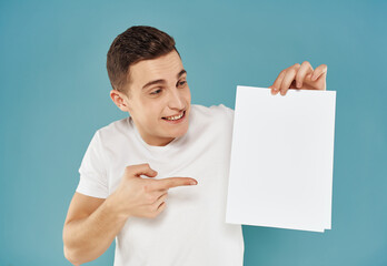 man in white t-shirt white sheet copy-space advertising blue background