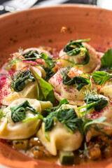 Homemade meat dumplings with spinach on top russian pelmeni on the table