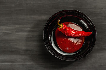 Ripe hot chili pepper on wooden boards background