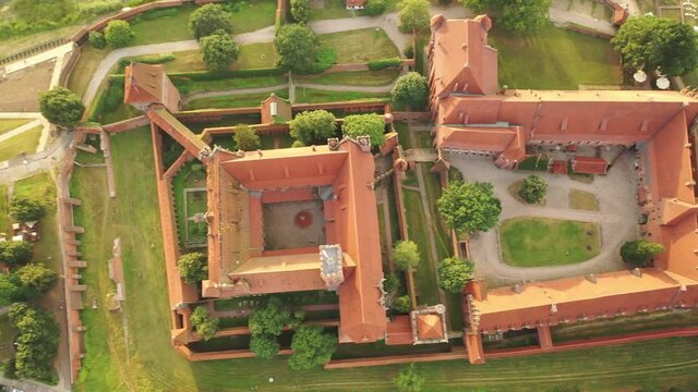 Malbork,Poland.Aerial 4K video from drone to Medieval Malbork ( Zamek w Maborku, Ordensburg Marienburg ),castle in Poland fortress of the Teutonic Knights at the Nogat river in sunset light.(Series)