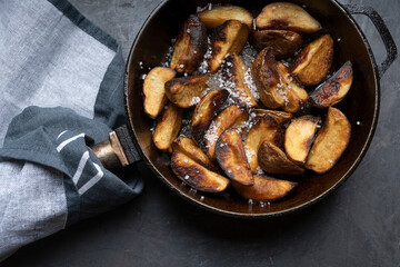 Fried potatoes in a skillet, junk food, fast food