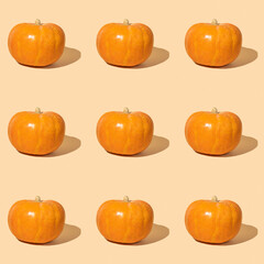 Seamless pattern with orange pumpkin on yellow background.