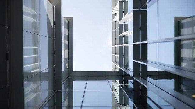 Metal and glass facade. Moderne architecture. Geometric facade. Aluminium frame.Reflections on glasses facade in a sunny day.