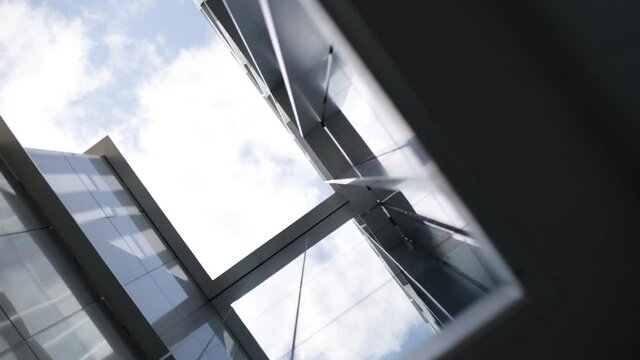 Metal and glass facade. Moderne architecture. Geometric facade. Aluminium frame.Reflections on glasses facade in a sunny day.