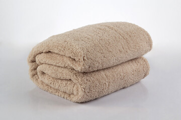 Fototapeta na wymiar Soft and warm of brown folded blanket isolated on white background