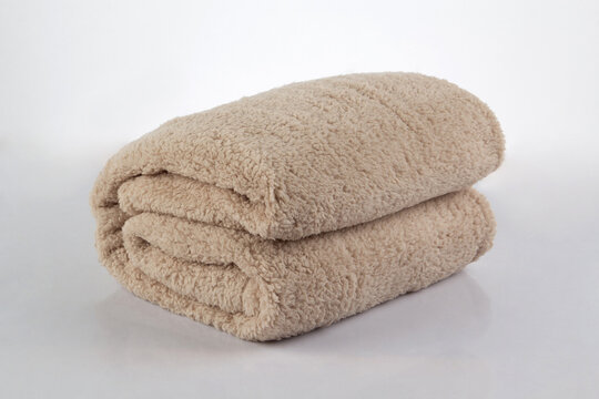 Soft and warm of brown folded blanket isolated on white background