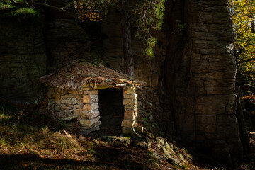 Small stone hut in the middle of a forest