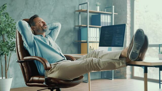 Positive relaxed man enjoy comfortable seat carefree armchair break concept
