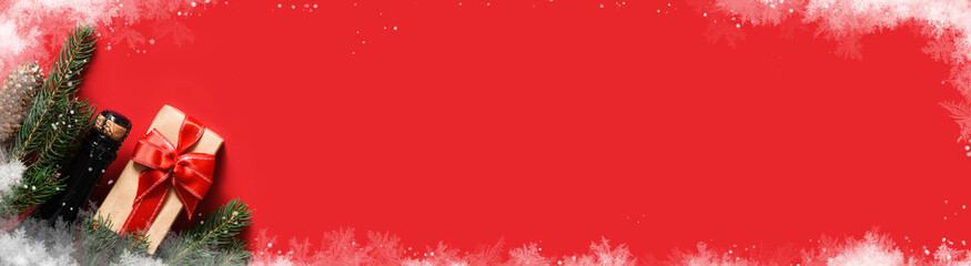 Christmas decoration on a red background, frost and snow. Red background with a fir and gifts with a ribbon.