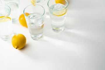 Water glasses background - copy space water in glasses with ice and citrons