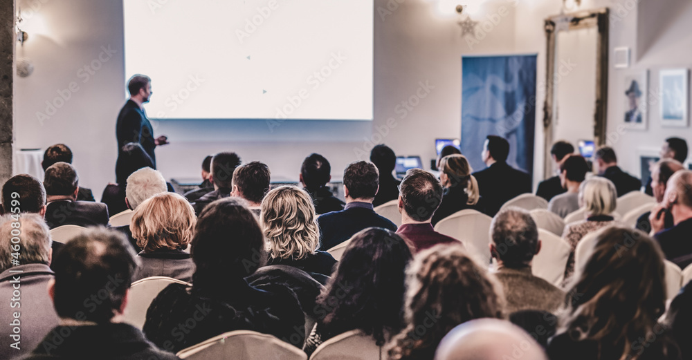 Wall mural Public speaker giving talk at Business Event.