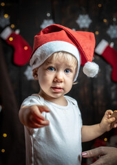 Cute baby boy surrounded with Christmas decorations