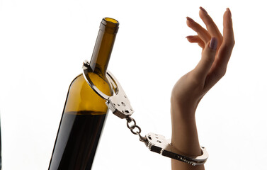 Hands chained to a bottle of alcohol. on white background.
