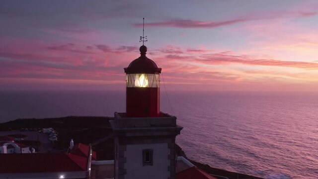 The Cabo da Roca Lighthouse, Sintra, Portugal, Europe. Steep cliffs under the purple skies as seen from top. Drone footage of a landmark surrounded with picturesque setting. High quality 4k footage