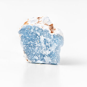 Blue calcium sulfate mineral rock isolated on white background. Angelite