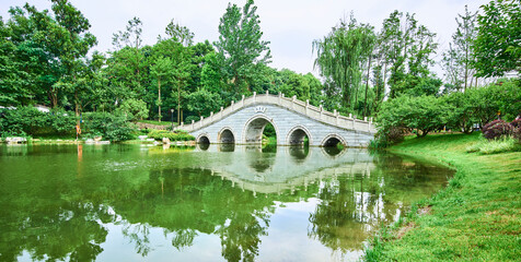 Fototapeta na wymiar An arch bridge in a park in Chengdu, Sichuan, China