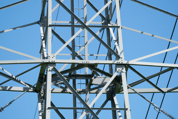 A part of a high-voltage electrical insulator electric line against the blue sky