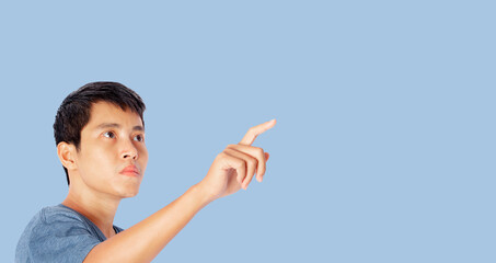 Young man pointing finger touching on screen isolated on blue background