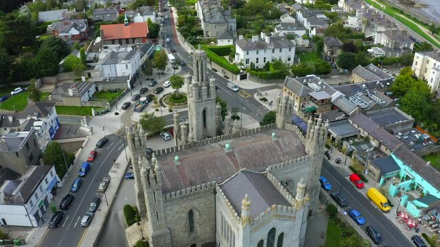 Monkstown Parish Church, Dublin, Ireland, September 2021. Drone gradually orbits the church in the center of the village with Monkstown Road and St. Patrick's Chruch in the background.