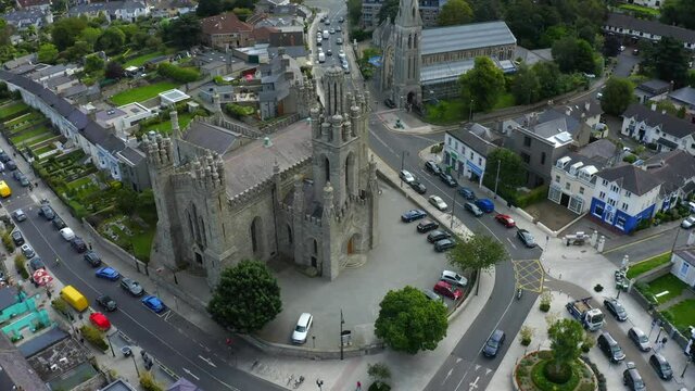 Monkstown Parish Church, Dublin, Ireland, September 2021. Drone gradually orbits the church in the center of the village with St. Patrick's Chruch and Monkstown Crescent in the background.