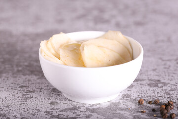 white radish slices with red pepper and oil