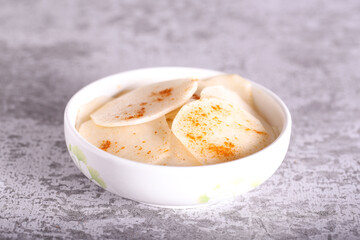 white radish slices with red pepper and oil