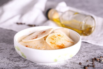 white radish slices with red pepper and oil