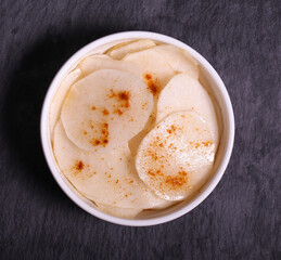 white radish slices with red pepper and oil