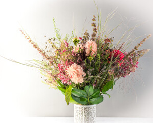 Autumn floral pink and orange decoration on grey wall background