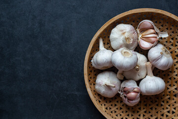 Garlic and Garlic Cloves and sliced garlic on dark grey background.