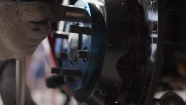 Close-up of a professional car repair with an wrench. Footage. Racing car in the service department.