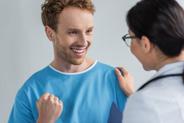 excited patient looking at doctor in glasses