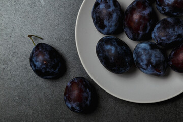 Fresh plums. Fruits. On a dark background. Copy space.