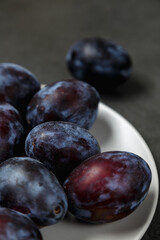 Fresh plums. Fruits. On a dark background. Copy space.