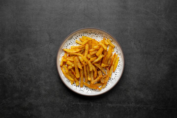 French fries on dark table, top view