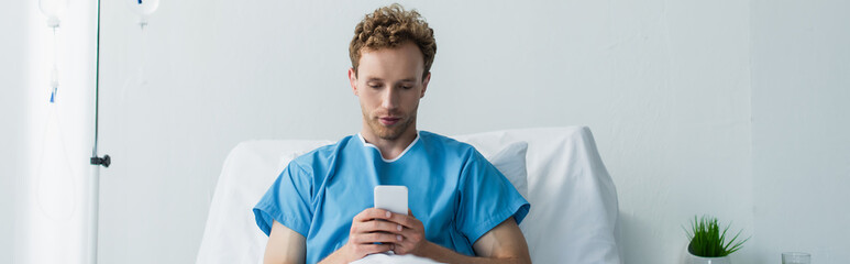 curly patient using smartphone while resting in hospital bed, banner